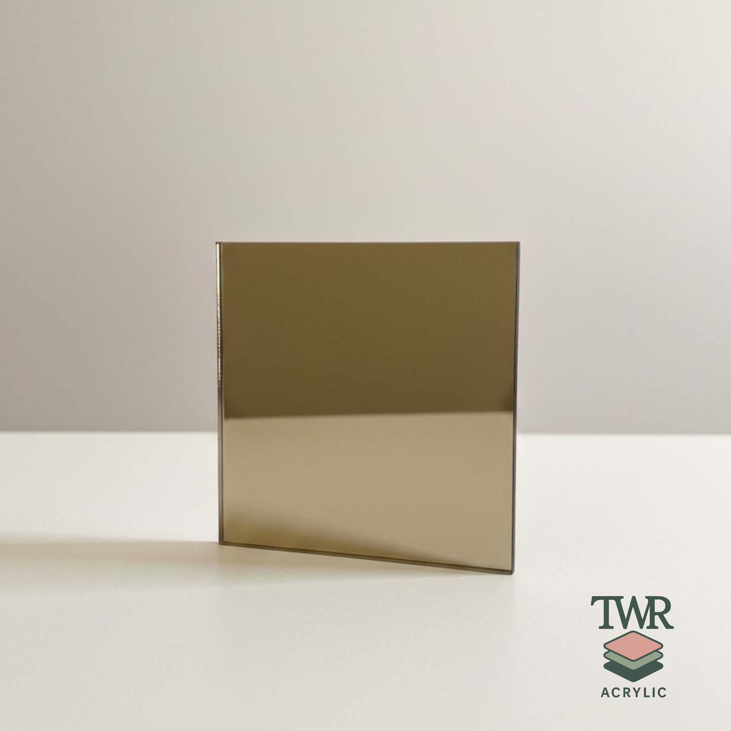 champagne mirror acrylic sheet on a white surface with TWR Acrylic logo.